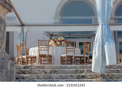 luxuriously laid tables with white tablecloths and floral arrangements, preparations for the wedding ceremony, on the open veranda of Vizcaya Villa, Miami,USA, Atlantic, summer, soft focus