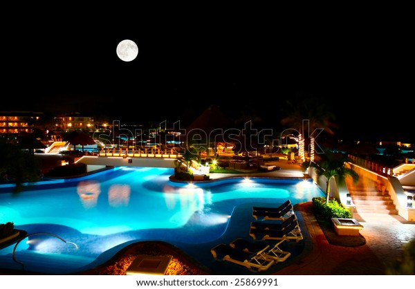 a luxury all inclusive beach resort at night in\
Cancun Mexico
