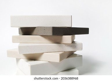 luxury artificial stone slab samples for kitchen countertops and wall tiles. samples of stone for countertops in side view showing edges (focus at edge of stone).