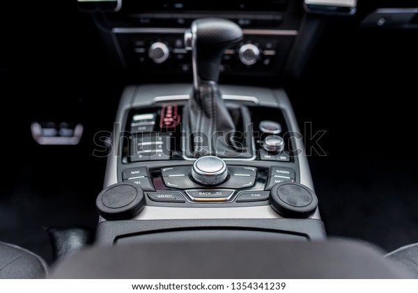 luxury automatic gearbox black\
leather lever with media control and mobile phone magnetic\
holder