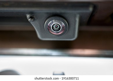 Luxury back car rear view camera close up for parking assistance in macro. Concept of safety car driving while parking process. Assist device equipment in modern cars