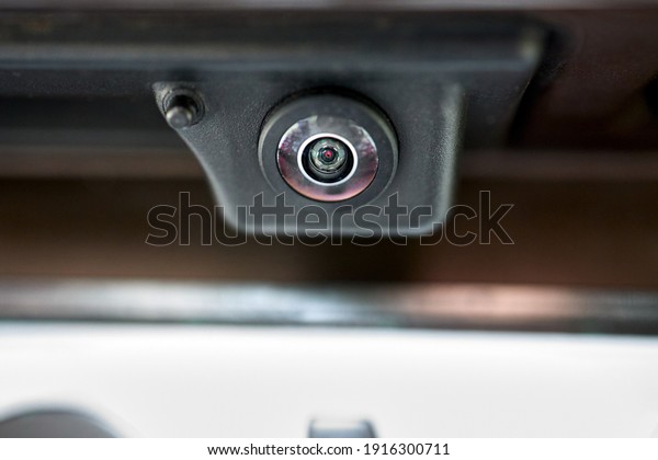 Luxury back car rear view camera
close up for parking assistance in macro. Concept of safety car
driving while parking process. Assist device equipment in modern
cars