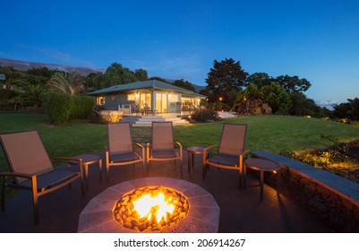 Luxury backyard fire pit at sunset