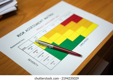 A Luxury Ballpoint Pen Is Placed On Risk Assessment Matrix Of Investment Project 2023 Evaluation Form. Object And Business Strategy Working Concept, Selective Focus.