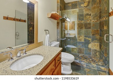 Luxury Bathroom Interior With Natural Stone Tiles Floor And Shower Surround.