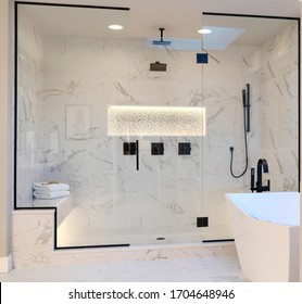 Luxury bathroom interior with tub, shower shelve and walk in shower. white marble and dark brown brass faucet. 