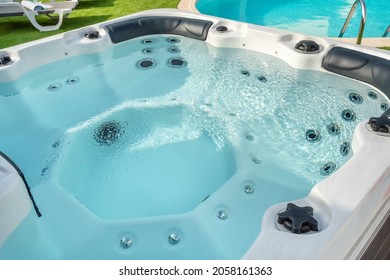 Luxury bathtub, for therapeutic massage and relaxation outside on the grass. Under the blue sky.
