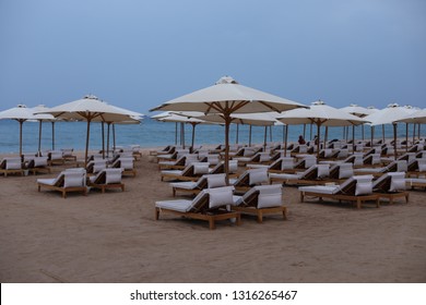 Luxury Beach With Deck Chairs In The Evening Time. Beautiful Landscape On The Coast Of Red Sea. View Of The Beach Of Baron Palace Sahl Hasheesh In Hurghada, Egypt.