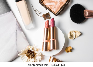 Luxury Beautiful Flat Lay Design Cosmetic Makeup Gold Nude Orange Pink Lipstick Foundation Blusher Bronzer Brush Flower Accessories White Background