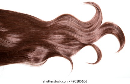 Luxury beautiful hair. A lock of curly voluminous healthy shiny hair on a white background.