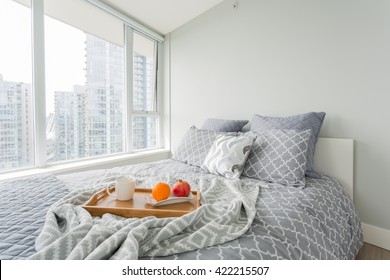 Luxury Bedroom. Contemporary Design With Reclaimed Wood Bedside Tables And Lamp. Nice And Cozy Accommodations. Hotel Or Resort Room. Vancouver Downtown View.