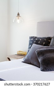 Luxury Bedroom Details Of Dark Grey Throw Pillows And Bedside Pendant Light