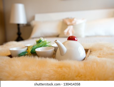 luxury bedroom interior with beverage on bed.