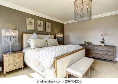 Luxury bedroom interior with carved wood bed, dresser and nightstands