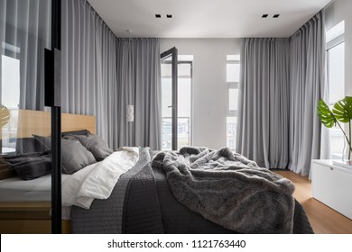 Luxury Bedroom Interior With Double Bed And Gray Window Curtains