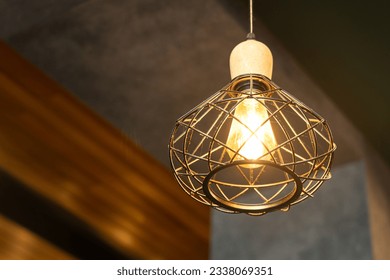 Luxury bird nest design of a metal ceiling  lighting lamp which is glowing in warmlight shade. Interior decoration object equipment, Close-up and selective focus. - Shutterstock ID 2338069351