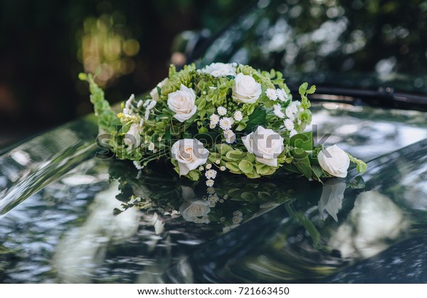 Luxury black\
wedding car decorated with\
flowers.