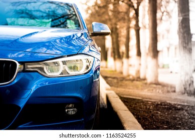 luxury blue car front view. sunlight