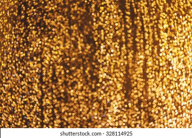 Luxury blurred background with bokeh stream of golden rain
