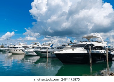 Luxury boat motor yacht in marina on Biscayne Bay. Sailboat moored to pier in yacht marina. Sailing and yachting tourism. Luxury lifestyle. Vacations on summer. Yacht at sea port. Yacht rental - Powered by Shutterstock