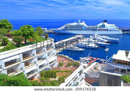 Luxury boats and large cruise ship inside the main harbor of Monaco 
