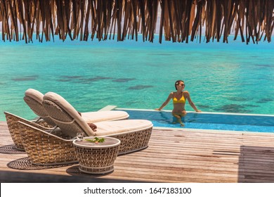 Luxury Bora Bora Resort Hotel Woman Vacation Woman Relaxing In Swimming Pool Of Private Hotel Room Overwater Bungalow Villa. Bikini Girl On Private Terrace With Infinity Ocean View Honeymoon's Suite.