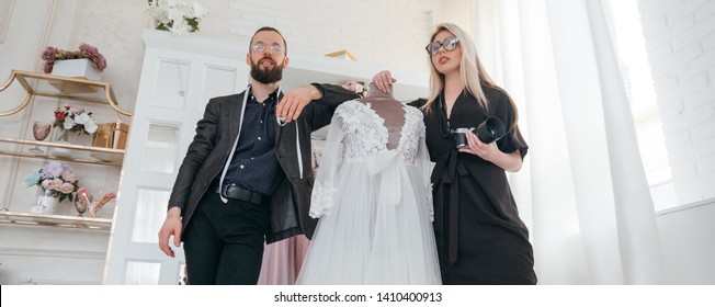 Luxury boutique. Modern business and teamwork. Fashion designer and photographer presenting gowns. - Shutterstock ID 1410400913
