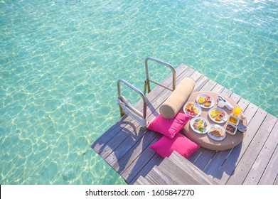 Luxury breakfast on sea  with beautiful tropical Maldives island , Morning time holiday vacation concept.