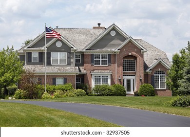 Luxury Brick Home In Suburbs With American Flag