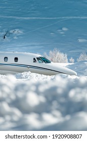 Luxury Business Jet Taxiing At Engadin Airport With Snow In The Foreground.