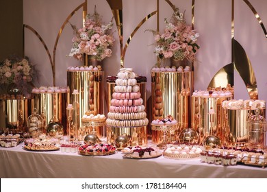 Luxury candy bar on golden wedding. Candy bar decorated by flowers standing of festive table with deserts, and cakes, strawberry tartlet, cupcakes and macarons. Wedding. Reception Tartlets - Shutterstock ID 1781184404