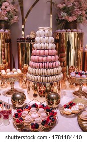 Luxury Candy Bar On Golden Wedding. Candy Bar Decorated By Flowers Standing Of Festive Table With Deserts, And Cakes, Strawberry Tartlet, Cupcakes And Macarons. Wedding. Reception Tartlets
