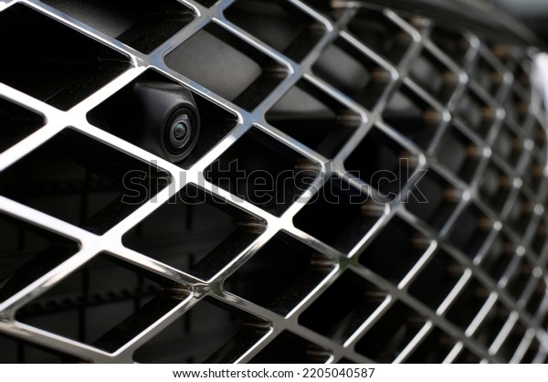 Luxury car front view camera for parking\
assistance selective focus\
close-up.