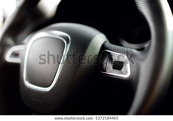 Luxury car interior details. Automatic gear stick of\
a modern car.