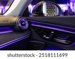 Luxury car interior featuring ambient lighting, sleek design, and premium materials.