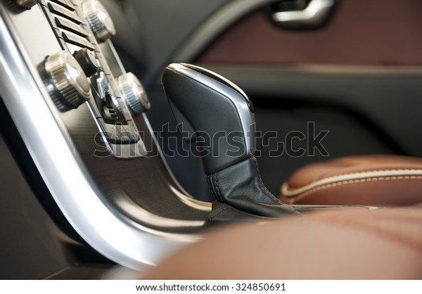 Luxury car\
interior with shift stick in the\
center