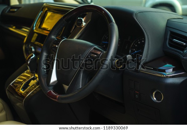 Luxury car interior. Steering wheel, shift
lever and dashboard.the inside of the
car