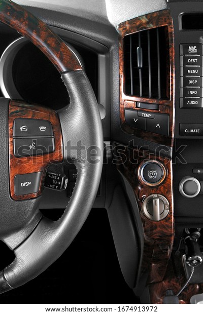 \
luxury car interior - steering wheel, shift\
lever and dashboard.