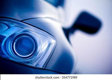 Luxury car Lexus xenon front headlight and mirror a blurry background