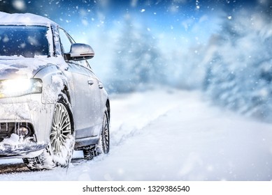 Luxury Car On Winter Road, Blur Mountains Background. Tires At Snow Highway.