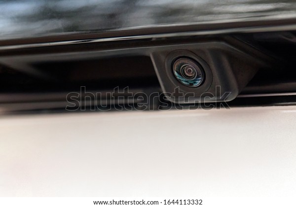 Luxury car rear view camera close up for\
parking assistance. Concept of safety car driving while parking\
process. Assist device equipment in modern\
cars
