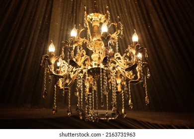 luxury Chandelier Luxury gold chandelier on wooden wooden deroration. Classical lighting equipment. Interior decoration image