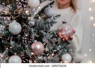 Luxury Christmas Tree With White, Silver And Pink Balls,  Snow And Glowing Garland. Girl Holding A Ball