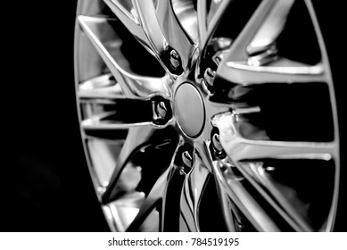 Luxury chrome alloy wheel in close-up as an automotive background (B&W HDR effect). 