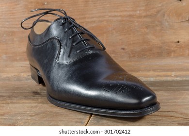 Luxury classic black shoe on wooden background
