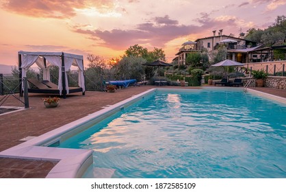 Luxury country house with swimming pool in Italy. Pool and old farm house during sunset central Italy. 