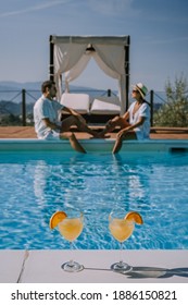 Luxury Country House With Swimming Pool In Italy. Pool And Old Farm House During Sunset Central Italy. Couple On Vacation At Luxury Villa In Italy, Men And Woman Watching Sunset