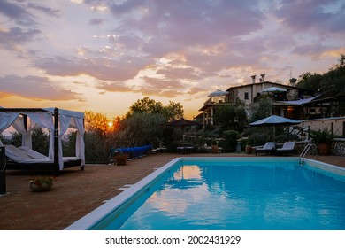 Luxury country house with swimming pool in Italy. Pool and old farmhouse during sunset central Italy. 