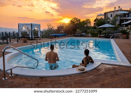 Luxury country house with swimming pool in Italy. Pool and old farmhouse during sunset in central Italy. Couple on Vacation at a luxury villa in Italy, men and woman watching the sunset.  Foto d'archivio © 