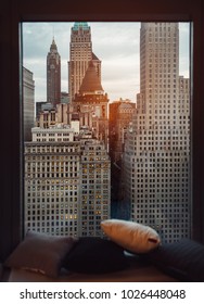 Luxury cozy window sill with view to New York City skyscrapers at sunset time. Coffee drinking place.